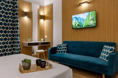 a living room with a blue couch and a table at Casa Palermo in Palermo