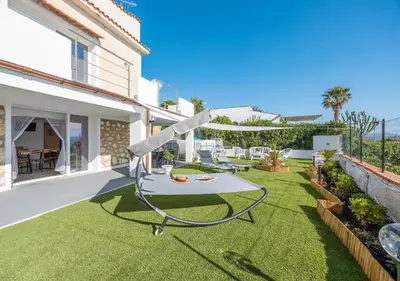 a table on the lawn of a house at Villa dei tramonti in Terrasini