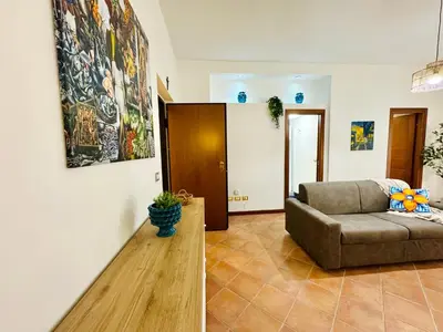 a living room with a couch and a table at Il Moro Suite in Palermo