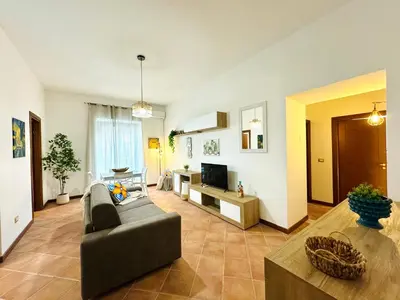 a living room with a couch and a tv at Il Moro Suite in Palermo