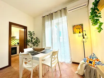 a dining room with a white table and chairs at Il Moro Suite in Palermo