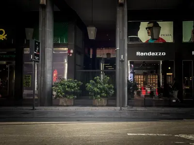 a store with potted plants in front of a building at UNA Room in Palermo