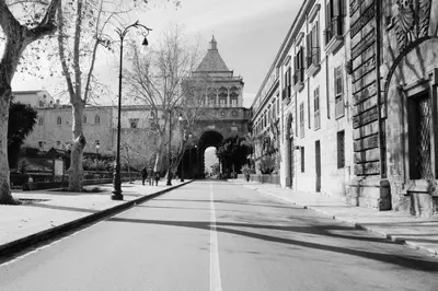 a black and white photo of a street with a tunnel at UNA Room in Palermo
