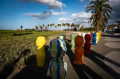 a row of different colored bottles on the side of a road at UNA Room in Palermo