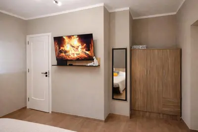 a bedroom with a fire painting on the wall at Casa Palù Sicilia in Altavilla Milicia