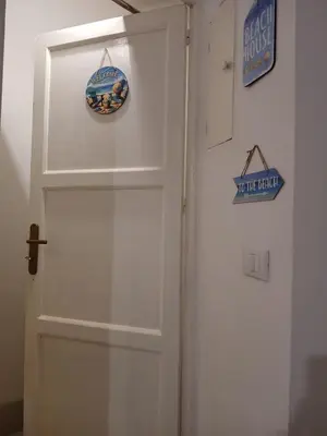 a white door with a sign on top of it at Sonalerba Ammare Trabia H H in Trabia