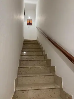 a staircase in a building with a painting on the wall at Sonalerba Ammare Trabia H H in Trabia