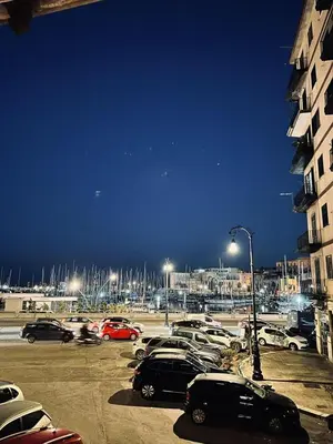 a parking lot with cars parked in a parking lot at B&B Al Porto Home in Palermo