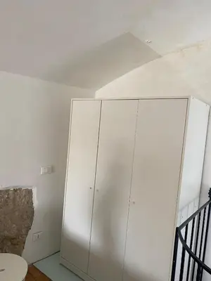 a white cabinet in a room with a ceiling at B&B Al Porto Home in Palermo