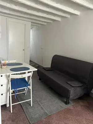 a room with a couch and a table and a desk at B&B Al Porto Home in Palermo