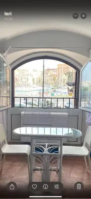 a table and two chairs on a boat at B&B Al Porto Home in Palermo