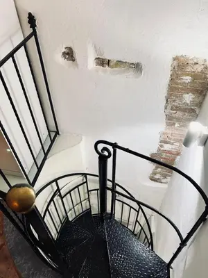 a black umbrella sitting on the side of a staircase at B&B Al Porto Home in Palermo