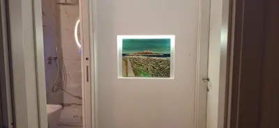 a picture hanging on the door of a bathroom at Idea di Mare in Capaci