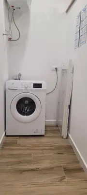 a washing machine in the corner of a room at Idea di Mare in Capaci