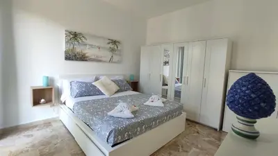 a bedroom with a bed with two stuffed animals on it at Villa Globo Mondello in Palermo