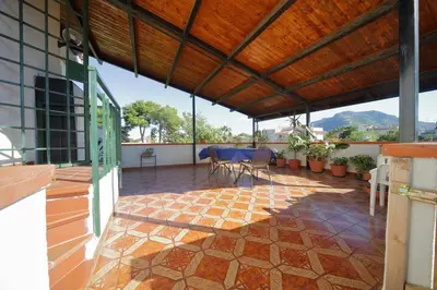 a patio with a table and chairs on a building at Villa Globo Mondello in Palermo