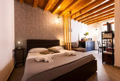a bedroom with a large bed with towels on it at Lampionelli 12 Apartment in Palermo