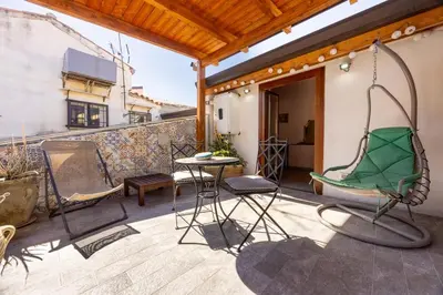 a patio with chairs and a table on a balcony at Lampionelli 12 Apartment in Palermo
