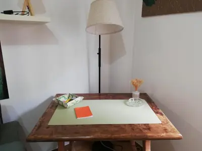 a table with a lamp on top of it at Bellammari Holiday House in Palermo