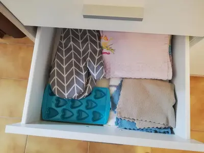 a shelf with towels and a bag on it at Bellammari Holiday House in Palermo