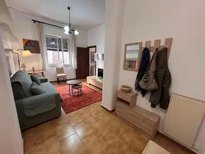 a living room with a couch and a table at Bellammari Holiday House in Palermo