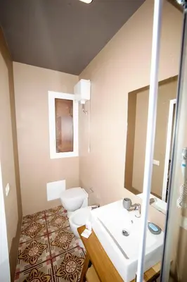 a bathroom with a sink and a toilet and a mirror at Visitsicilia Donn'Anna in Castellammare del Golfo
