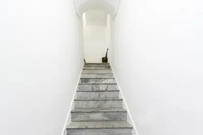 a stairway leading up to a white building at Visitsicilia Donn'Anna in Castellammare del Golfo
