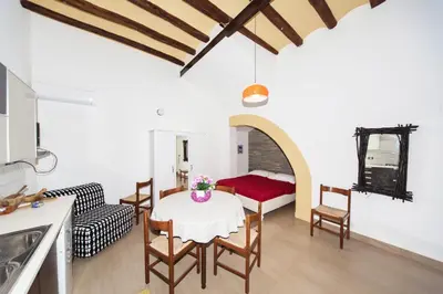 a kitchen and living room with a table and chairs at Visitsicilia Donn'Anna in Castellammare del Golfo