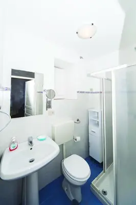 a bathroom with a toilet and a sink and a shower at Visitsicilia Donn'Anna in Castellammare del Golfo