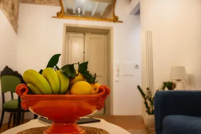 an orange bowl of fruit on a table at AthaHome Deluxe in Palermo