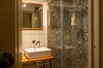 a bathroom with a sink and a shower at AthaHome Deluxe in Palermo