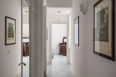 a hallway with two pictures on the walls at Villa Angela By DomuSicily in Capaci