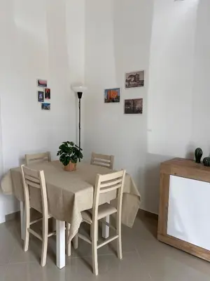 a dining room table with chairs and a plant on it at Zisa Apartment Palermo in Palermo