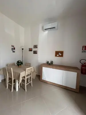 a dining room with a table and chairs and aperature at Zisa Apartment Palermo in Palermo