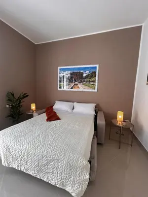 a bedroom with a bed and two lights on two tables at Zisa Apartment Palermo in Palermo
