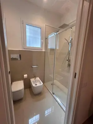 a bathroom with a shower and a toilet and a sink at Zisa Apartment Palermo in Palermo