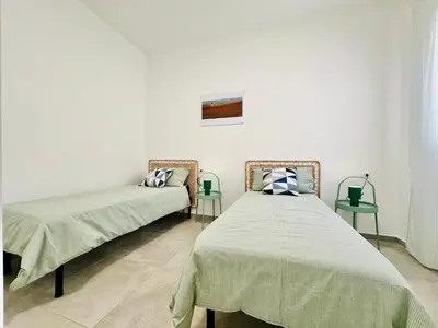 two beds sitting next to each other in a room at Sea Life Giulia, spiaggia a 200 mt in Alcamo Marina