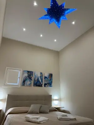 a bedroom with a bed with a blue star on the ceiling at Mart Rental Apartament in Palermo