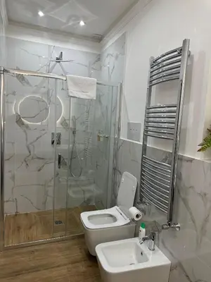 a bathroom with a shower and a toilet and a sink at Mart Rental Apartament in Palermo