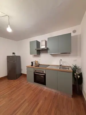 an empty kitchen with a sink and a refrigerator at Houel's House in Palermo
