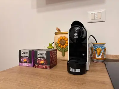 a kitchen counter with a blow dryer and products on it at Houel's House in Palermo