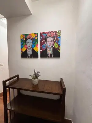 three paintings of a man on a wall at Houel's House in Palermo