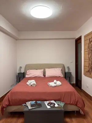 a bedroom with a bed with two towels on it at Houel's House in Palermo
