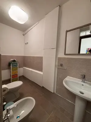 a bathroom with two toilets and a sink and a mirror at Houel's House in Palermo