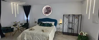a bedroom with a bed and a moon on the wall at The Moon Suite in Palermo