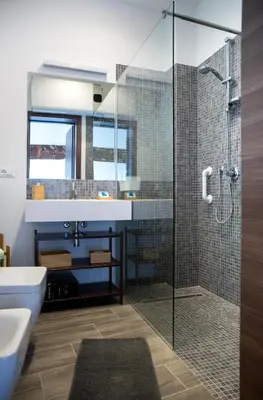 a bathroom with a glass shower and a sink at Apartments Porta di Castro in Palermo