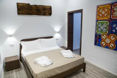 a bedroom with a bed with two towels on it at Apartments Porta di Castro in Palermo