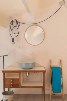a bowl on a wooden table with a mirror at Il Moro & La Dama in Palermo
