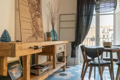 a living room with a table and a chair at Il Moro & La Dama in Palermo