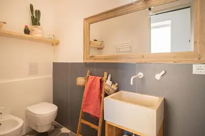 a bathroom with a sink and a toilet and a mirror at Il Moro & La Dama in Palermo